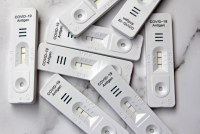 A photo of a pile of covid-19 at-home tests.