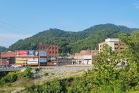 A photo of a downtown area with mountains seen in the background.