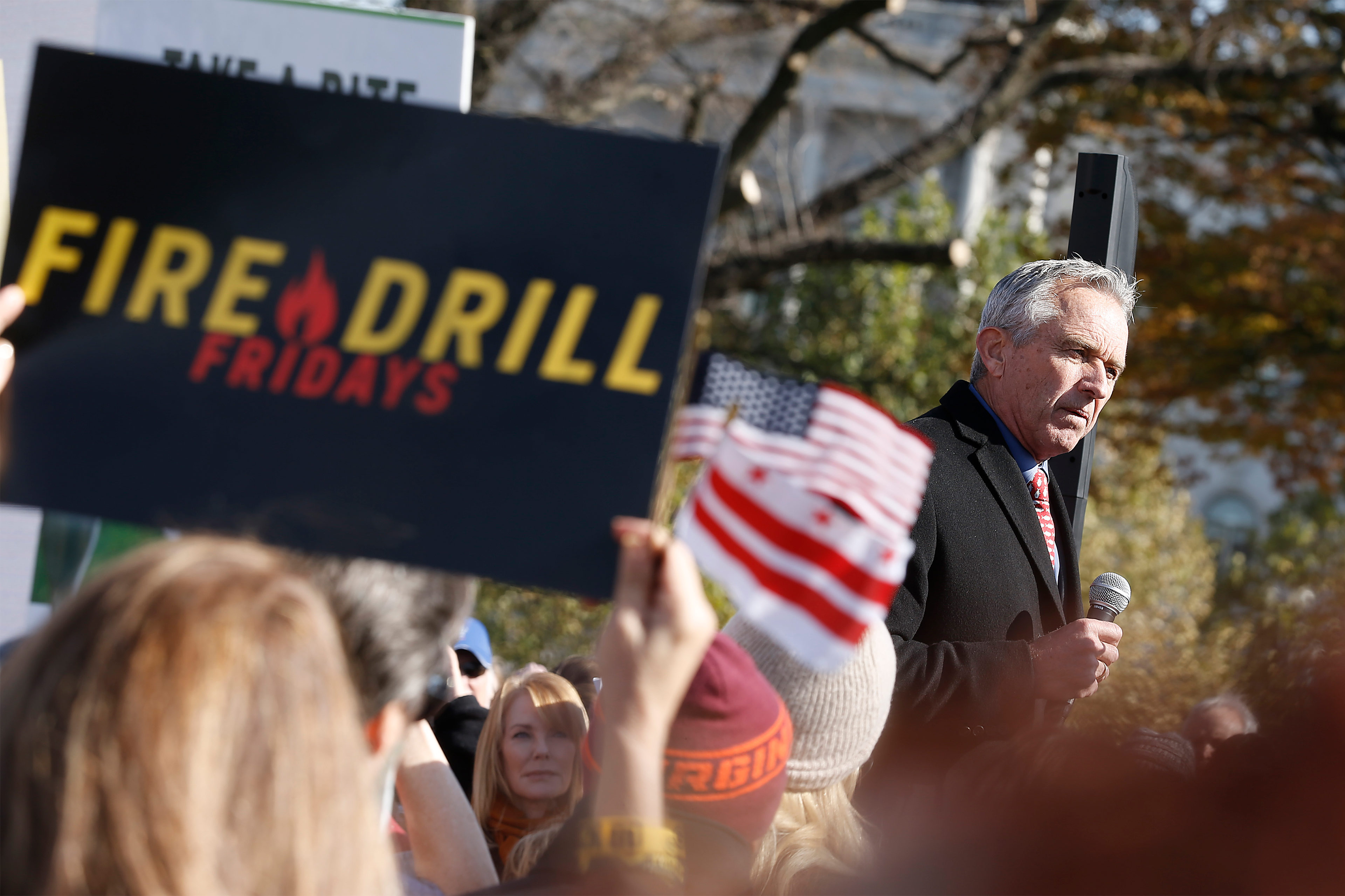 A photo of Robert F. Kennedy Jr. speaking before a crowd of protesters.